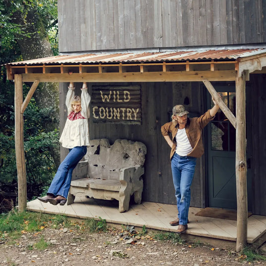 Man and woman outside a cowboy western ranch wearing Durango western boots.